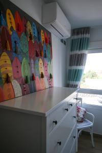 a kitchen with a counter and a wall with surfboards at Villa Golf y Mar in San Miguel de Abona