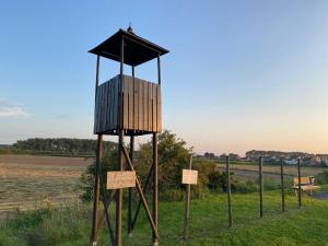 a wooden observation tower on display in a field at Zelzate dichtbij Gent-Brugge in Philippine