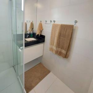 a bathroom with a sink and a glass shower at Na Morada dos Milagres, condomínio Morada do Toque in São Miguel dos Milagres