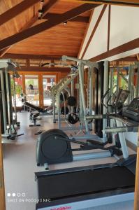 a gym with several treadmills and machines in a room at PRAIA DO FORTE - PISCINAS NATURAIS in Praia do Forte