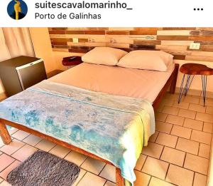 a bedroom with a large bed with avisor at Suítes Cavalo Marinho in Porto De Galinhas