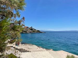 a view of the ocean from the shore of a beach at Apartments Papic in Trogir