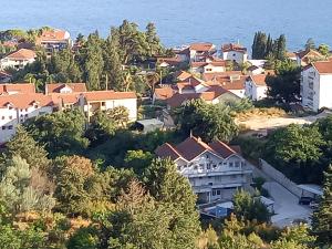 an aerial view of a house on a hill next to the ocean at Apartmani Nevena in Herceg-Novi