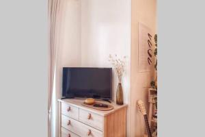 a tv on top of a dresser in a room at Modern apartment with sauna and free parking in Kuopio
