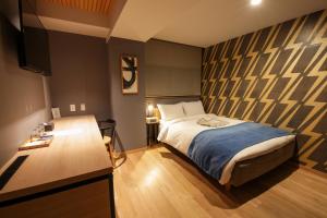 Rúm í herbergi á Asakusa Kokono Club Hotel