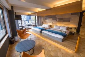 Rúm í herbergi á Asakusa Kokono Club Hotel