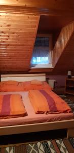 a large bed in a room with a staircase at Maya Vendégház in Abádszalók