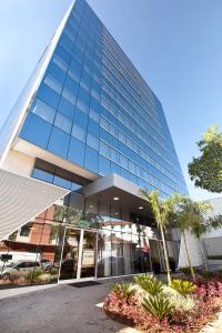 a tall glass building with a lot of windows at eSuites Savassi Toscanini in Belo Horizonte