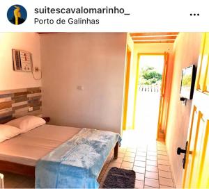 a bedroom with a bed and a door to a room at Suítes Cavalo Marinho in Porto De Galinhas