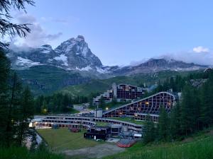 a view of a resort with a mountain in the background at Cervinia Ski In Ski Out - Spacious Apartment in Breuil-Cervinia