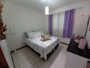 a bedroom with a bed with a table on it at Stúdio Petrópolis, Alameda das Pedras in Petrópolis +64 photos