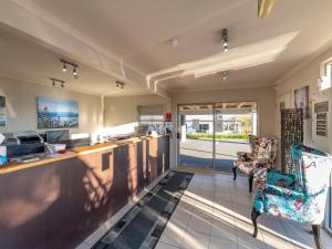 an office with a reception desk and a chair at Lake Taupo Motor Inn in Taupo