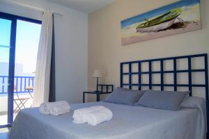 a bedroom with a bed with towels on it at Casa Tacande in Yaiza