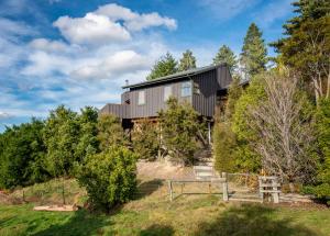 a house on top of a hill with trees at 'Love' Hanmer Couples Retreat Limited in Hanmer Springs