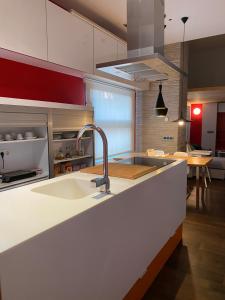 a kitchen with a sink and a counter top at Cozy designer apart / Acogedor apartamento de diseño ● WiFi - Jacuzzi - A/C SteamSauna in Madrid