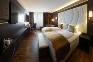 מיטה או מיטות בחדר ב-Best Western Plus Plaza Hotel Darmstadt