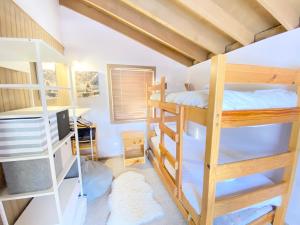 a room with two bunk beds and a desk at High Bernation Haus in Dinner Plain