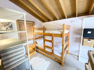 a room with bunk beds and a desk at High Bernation Haus in Dinner Plain +3 photos