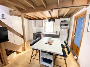 a kitchen with a table and chairs in a room at High Bernation Haus in Dinner Plain