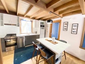 a kitchen with a table and some chairs in it at High Bernation Haus in Dinner Plain