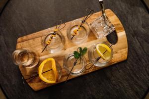 a wooden tray with glasses and lemon slices on it at Freycinet Lodge in Coles Bay