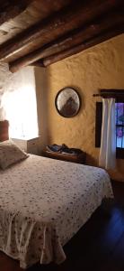 a bedroom with a white bed and a mirror at Casa rural El Patio con chimenea, barbacoa, piscina, patios exteriores para sus mascotas de manera gratuita in Benadalid +42 photos