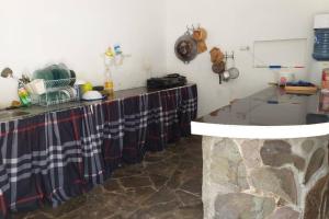 a kitchen with a counter with a stone counter top at Villa Dhanty in Bogor