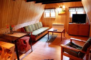 a living room with a couch and a table at Rehe Turismitalu in Kuijõe