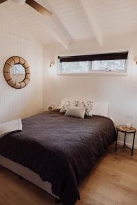 a bedroom with a large bed with a window at Wallinga Farmstay Mudgee in Mudgee