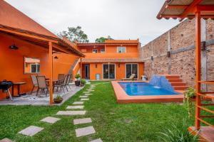 a backyard with a swimming pool and a house at Riberas Suites in Chapala +14 photos
