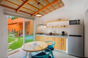 a kitchen with a table and a refrigerator at Riberas Suites in Chapala