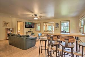 a living room with a couch and a bar with stools at Waterfront Leech Lake Cabin with Dock, Fire Pit in Cass Lake