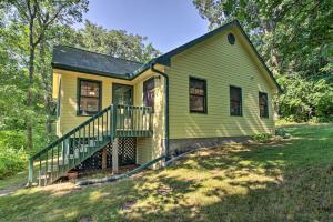 a yellow house with a staircase in the yard at Waterfront Leech Lake Cabin with Dock, Fire Pit in Cass Lake