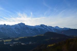 a view of a mountain range with snow capped mountains at Möselberghof in Abtenau