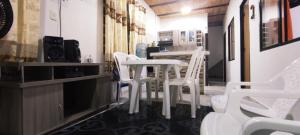 una fila de sillas y mesas blancas en un restaurante en Melgar-Tolima Casa la estrella, en Melgar