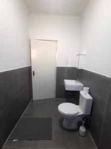 a bathroom with a white toilet and a sink at the hide on 78 in East London