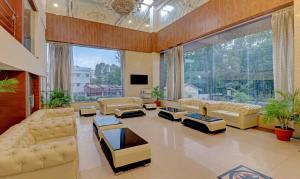 a large living room with couches and a large window at Treebo Tryst Pearl Avenue in Dehradun