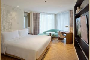 a hotel room with a bed and a desk at Grand Josun Busan in Busan