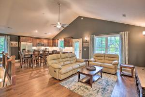 a living room with two couches and a kitchen at Massanutten Resort Retreat with Hot Tub and Game Room! in Massanutten
