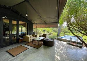 a living room with a couch and a table at Leopard Trails Yala in Yala