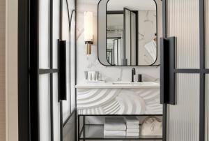 a bathroom with a sink and a mirror at Grand Josun Busan in Busan