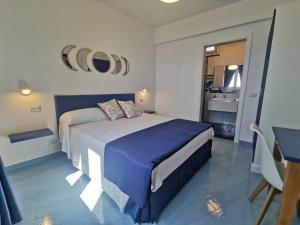 a bedroom with a large bed and a bathroom at Lena Magda B&B in Furore
