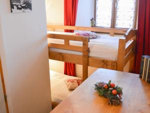 a bedroom with two bunk beds and a table at Studio Valloire, 1 pièce, 4 personnes - FR-1-263-81 in Valloire