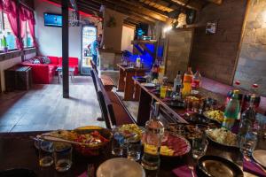 a restaurant with a table with plates of food at Guest House Markovi in Govedartsi