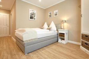a bedroom with a large bed and a television at Zum Landsberger Hof in Arnsberg