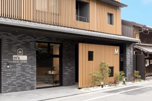 ein Bürogebäude mit einer schwarzen und orangefarbenen Fassade in der Unterkunft M's Hotel Sanjo Omiya in Kyoto