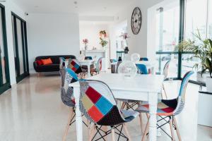 a dining room with a white table and chairs at Hostal Noray in Punta Prima +40 photos