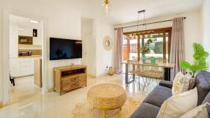 a living room with a couch and a table at Tinajas Chic in Corralejo