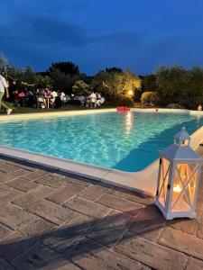 a swimming pool at night with a light next to it at La Ginestra in Todi