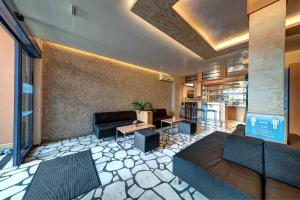 a living room with a couch and a table at Paloma - in the center of the city in Sunny Beach